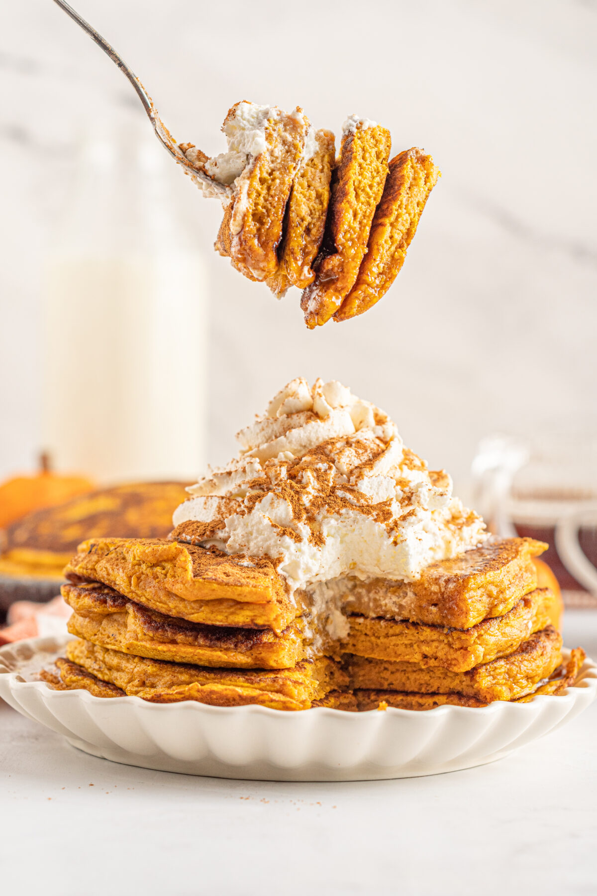 This easy pumpkin pancakes recipe uses real pumpkin, and has the perfect blend of warming spices for a delicious fall brunch or breakfast.