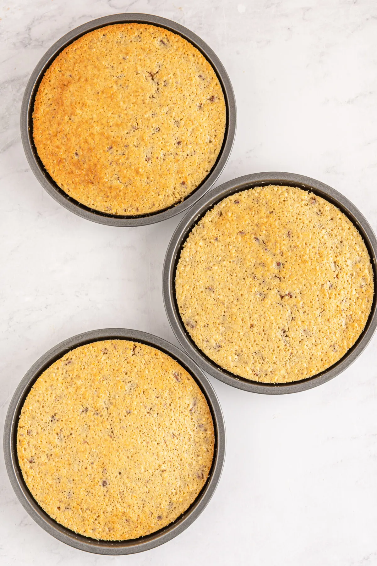 Cakes baked in three cake pans.