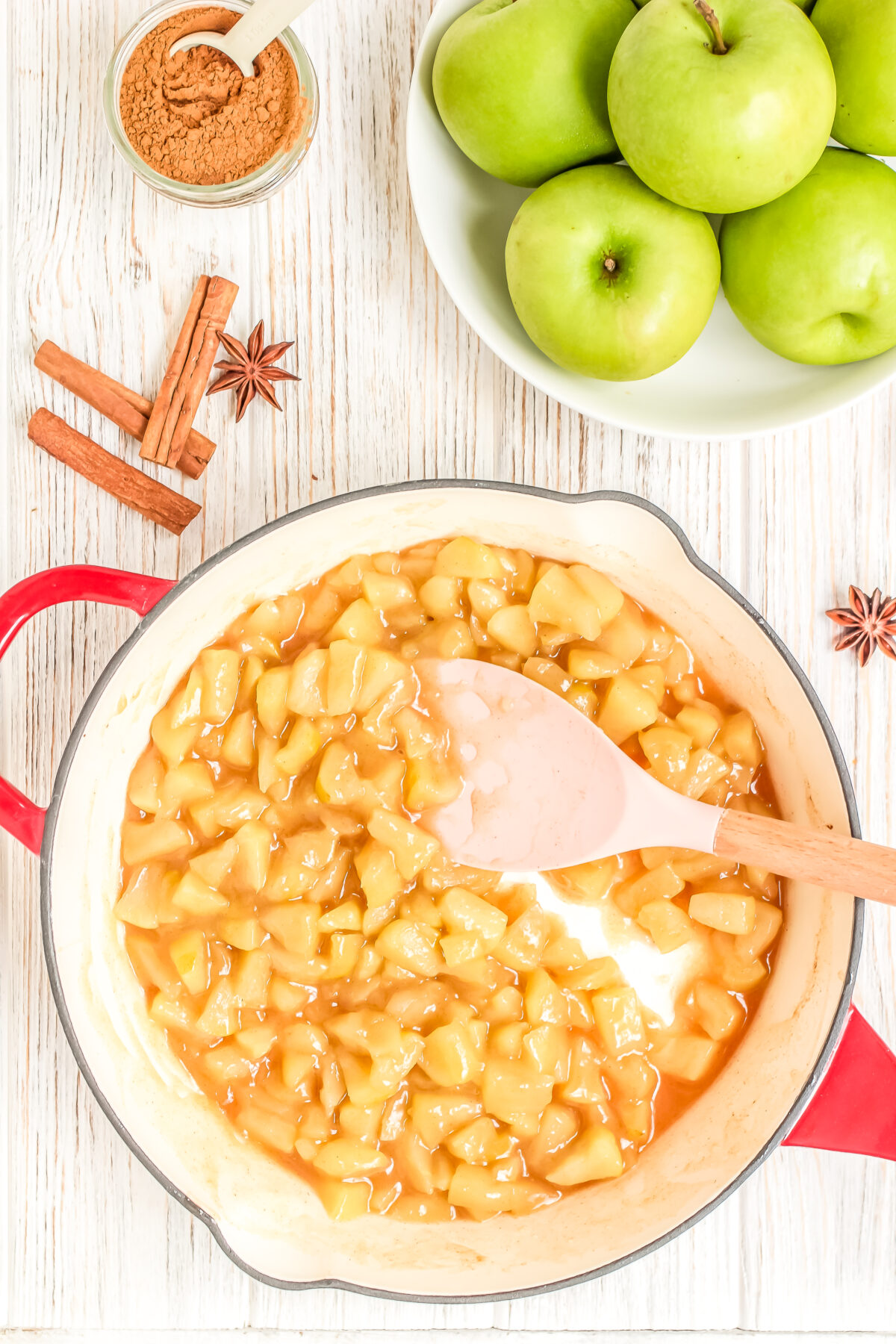 Apple juices thickened with cornstarch in the skillet.
