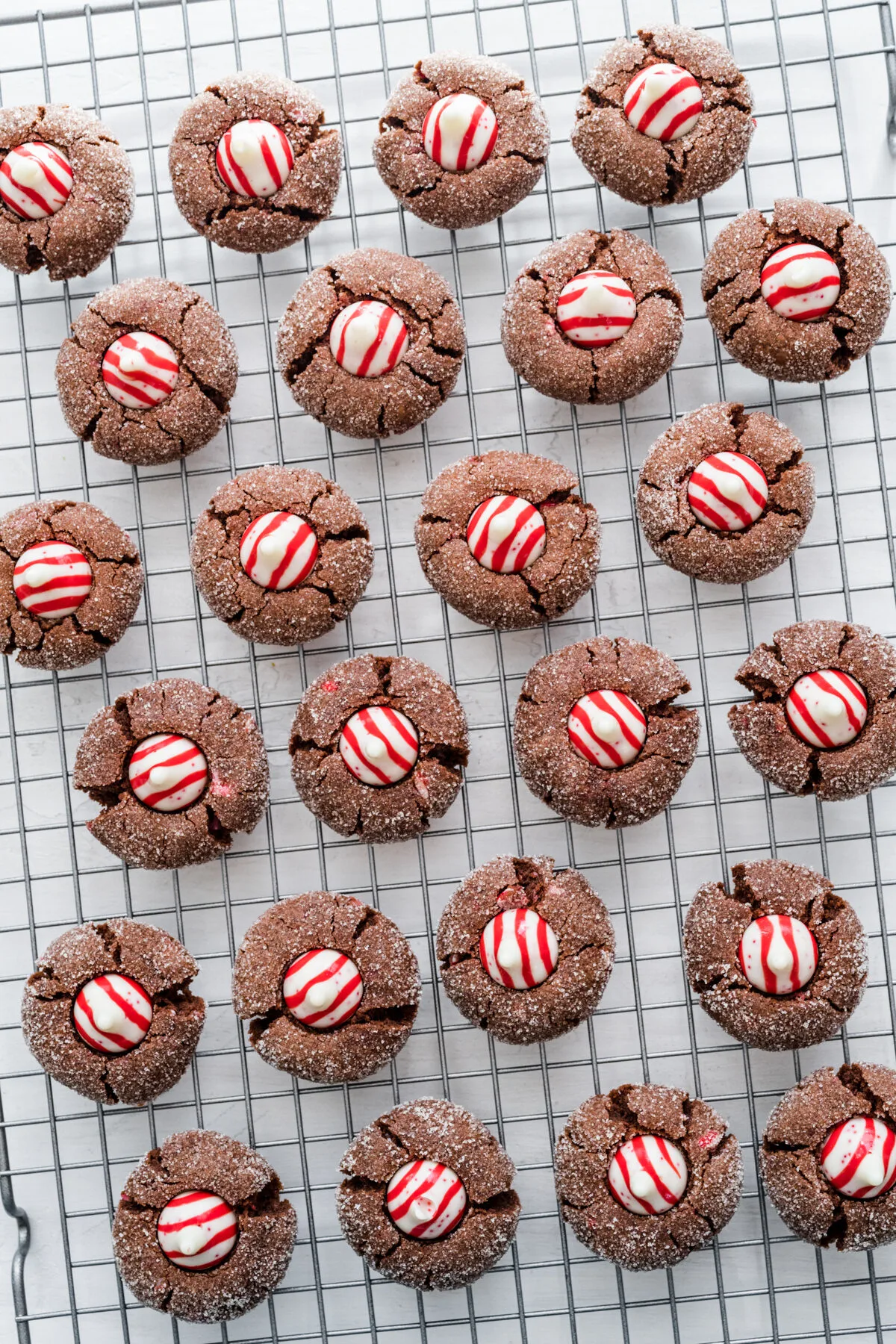Chocolate peppermint kiss cookies cooling off on a wire rack.