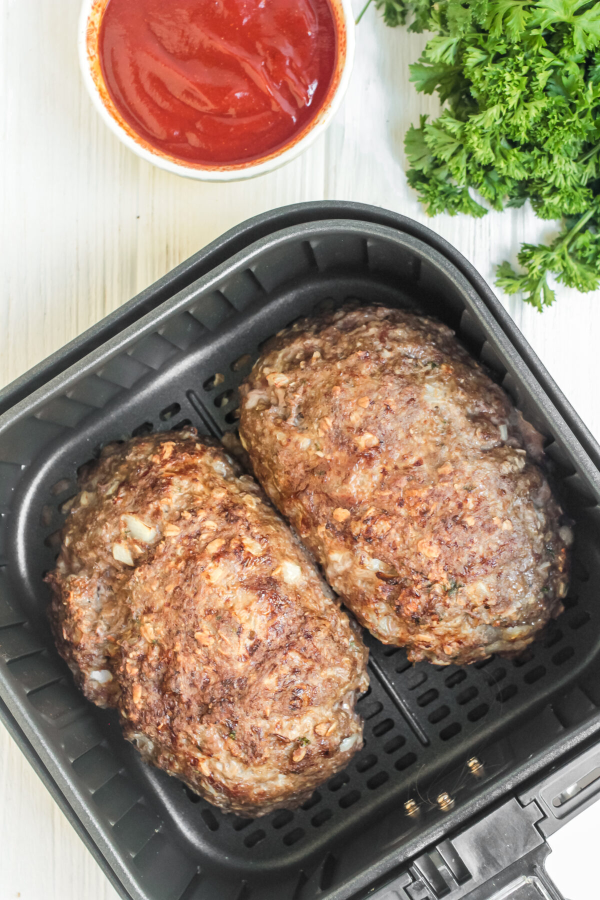 Meatloaves cooked in the air fryer basket.