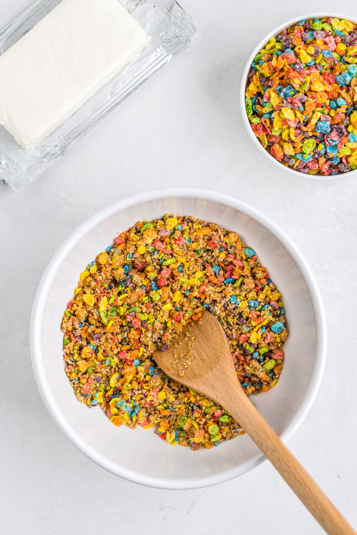 Fruity pebbles, graham cracker crumbs, butter and salt combined together in a bowl.