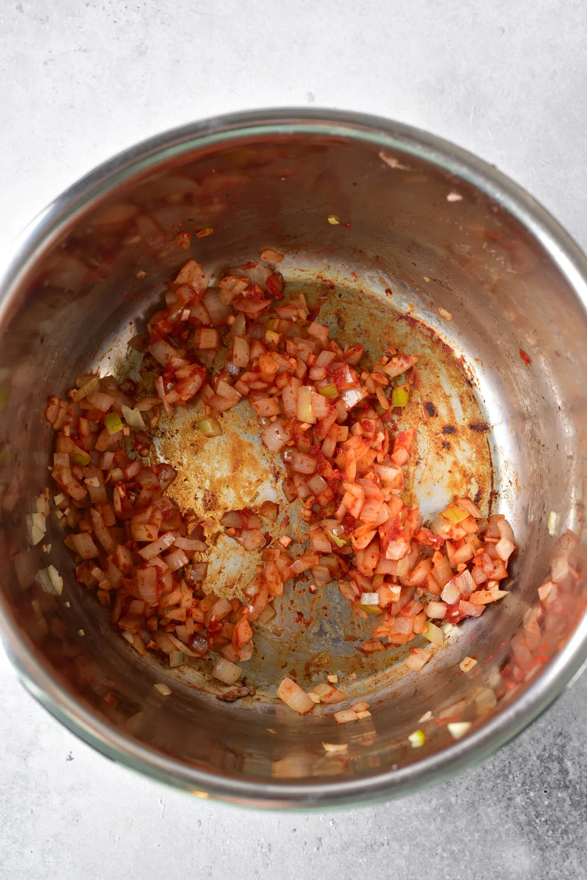 Tomato paste added to the onion and garlic in the instant pot.