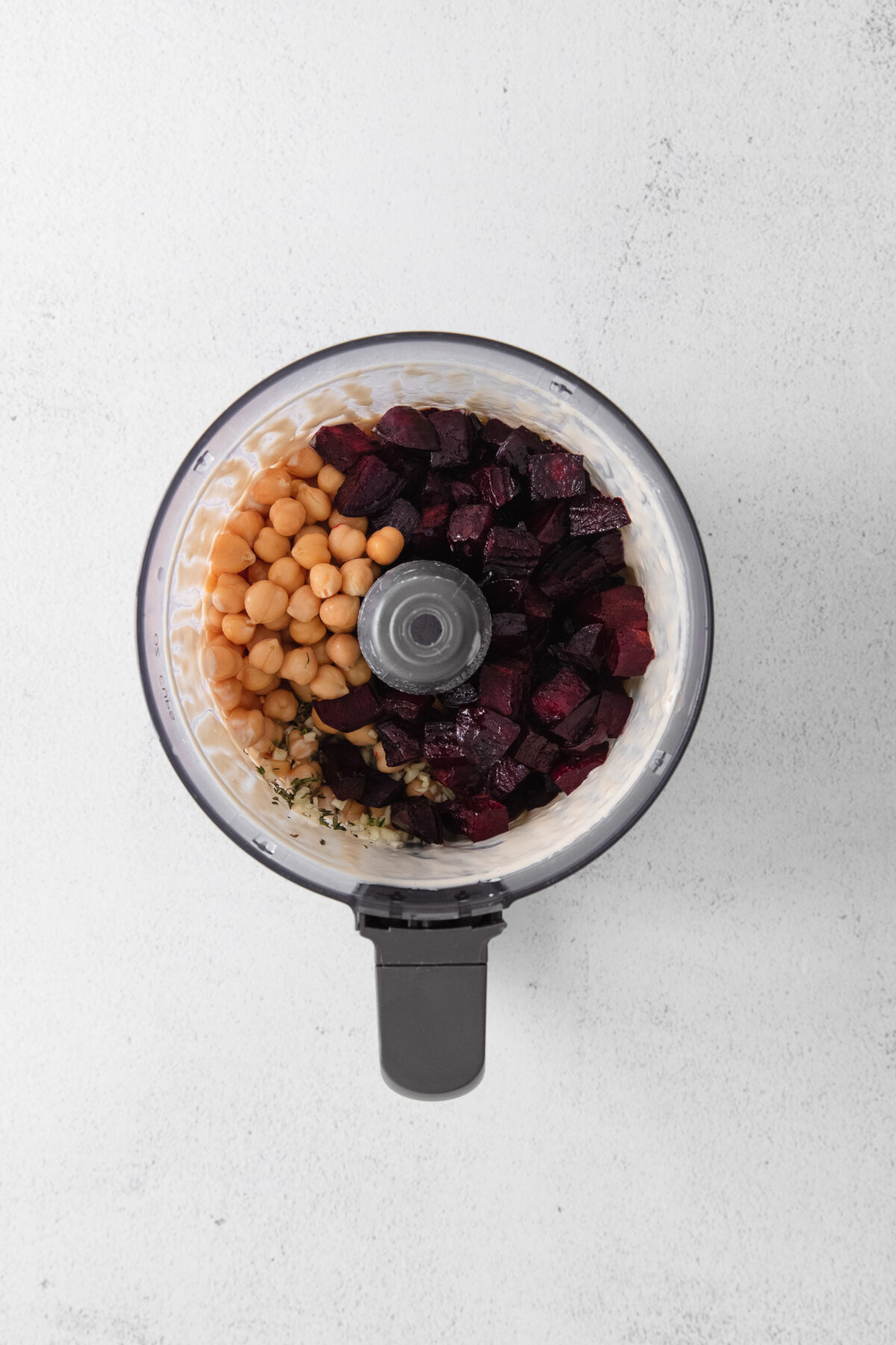 Food processor with chickpeas and roasted beets.