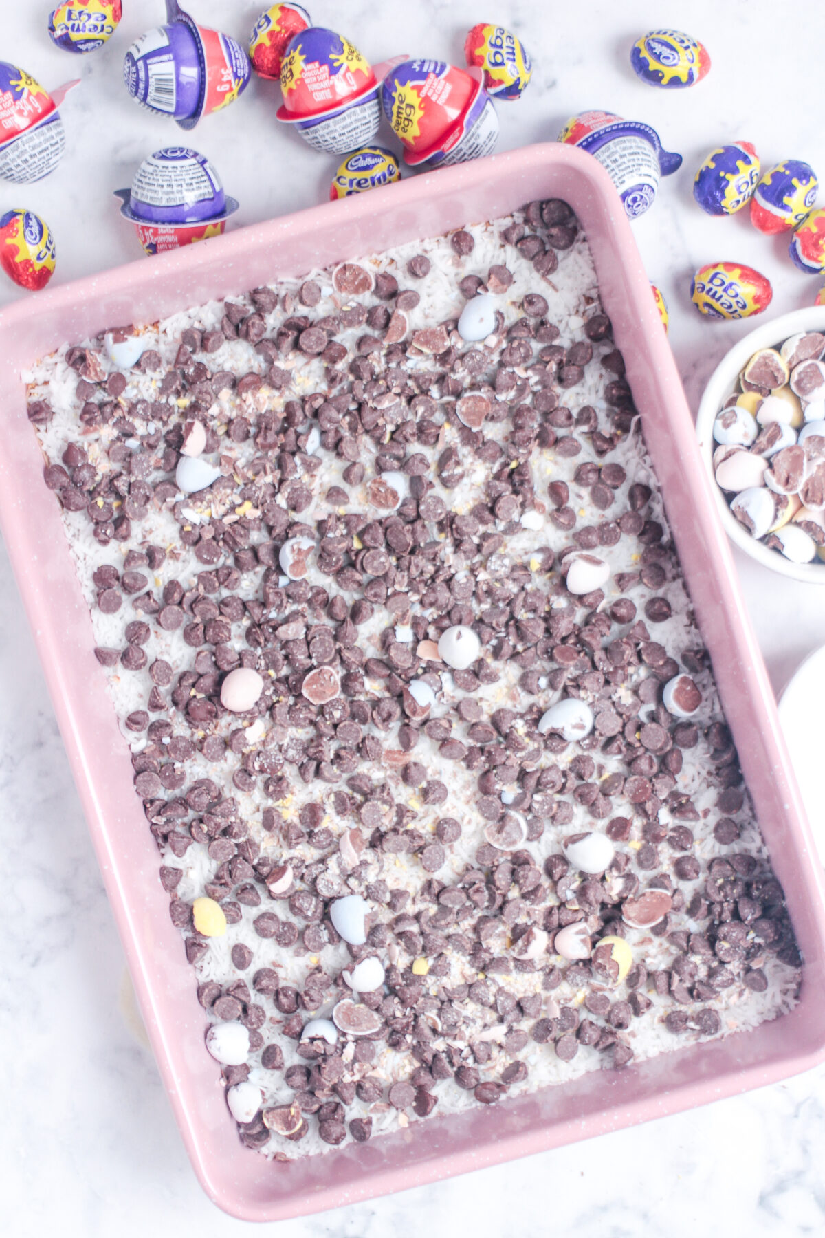 Chocolate chops and mini eggs layered over the coconut.