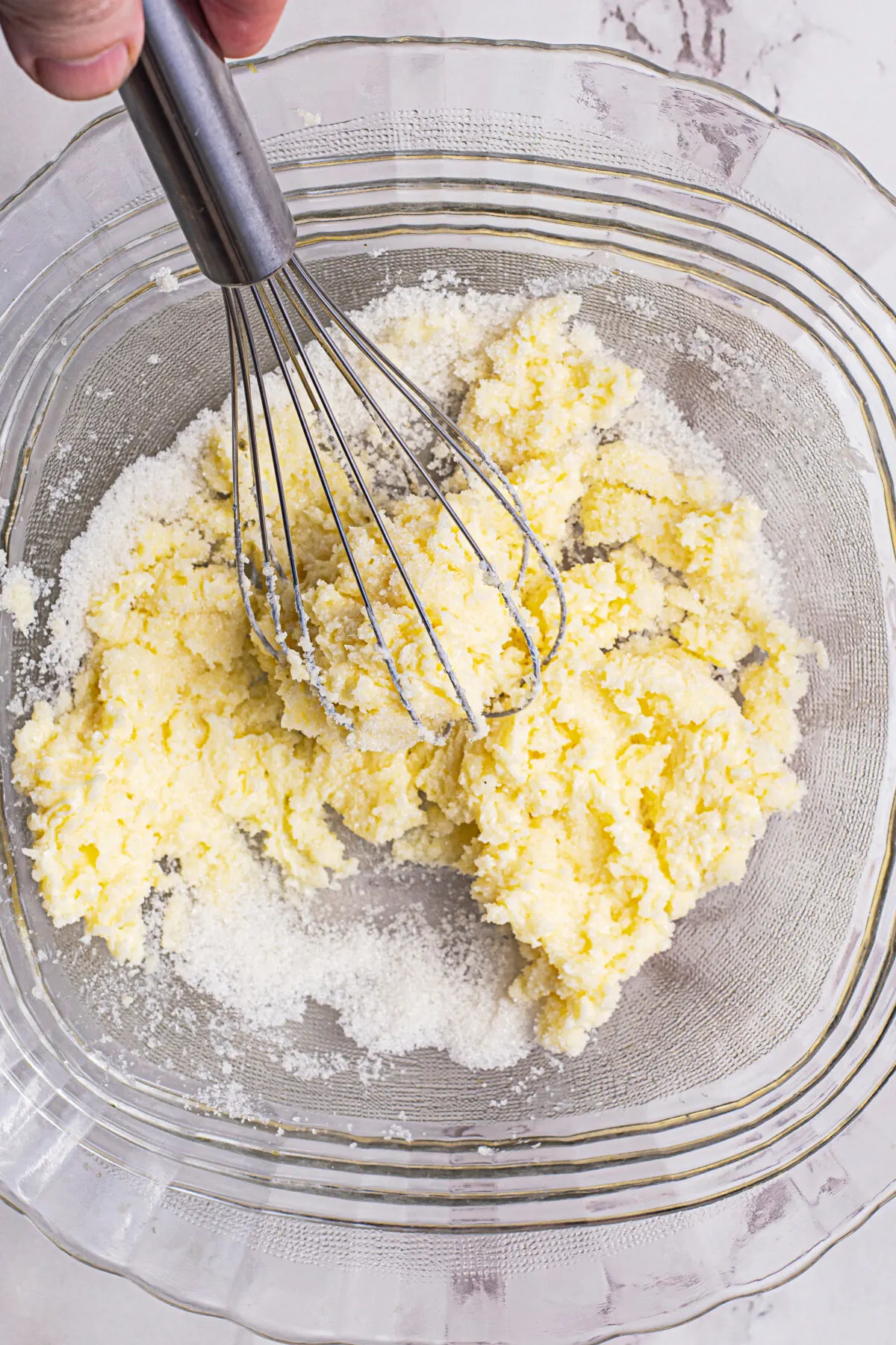 Creaming butter and sugar in a bowl.