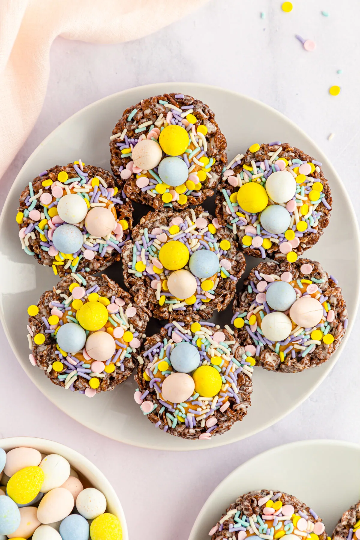 Celebrate this Easter with these Cocoa Pebbles Easter Nests filled with creamy peanut butter and topped off with chocolate eggs.