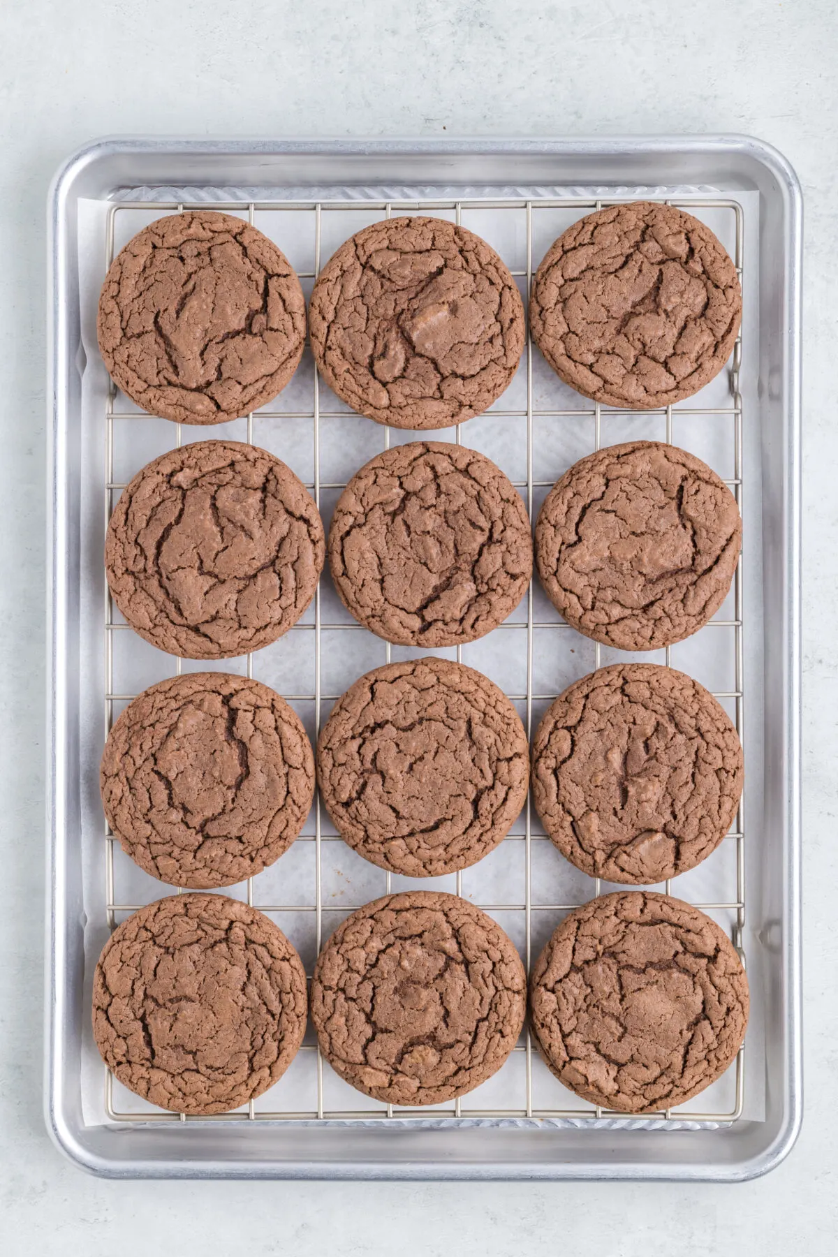 Baked cookies on a wire rack set inside the baking pan.