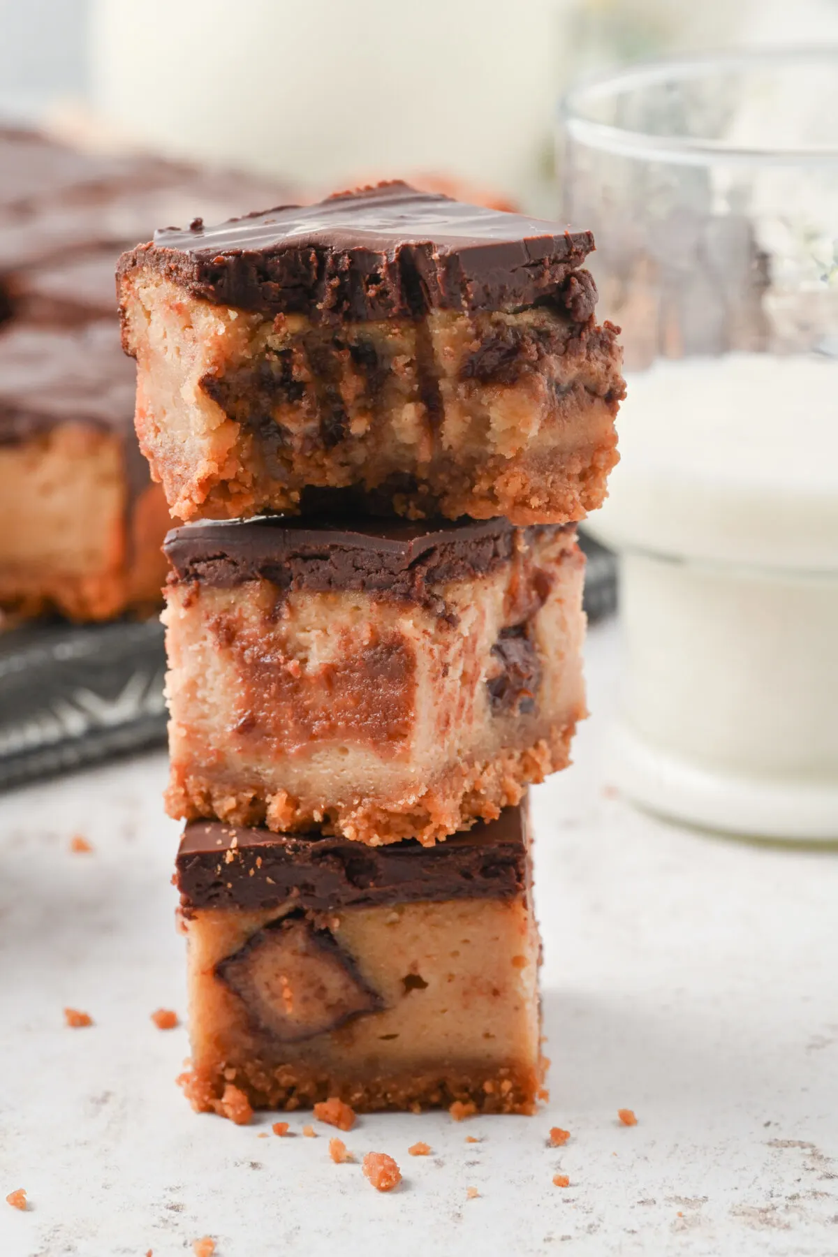 Peanut butter cheesecake bars recipe featuring a nutter butter crust, creamy cheesecake layer, topped off with a silky chocolate ganache.