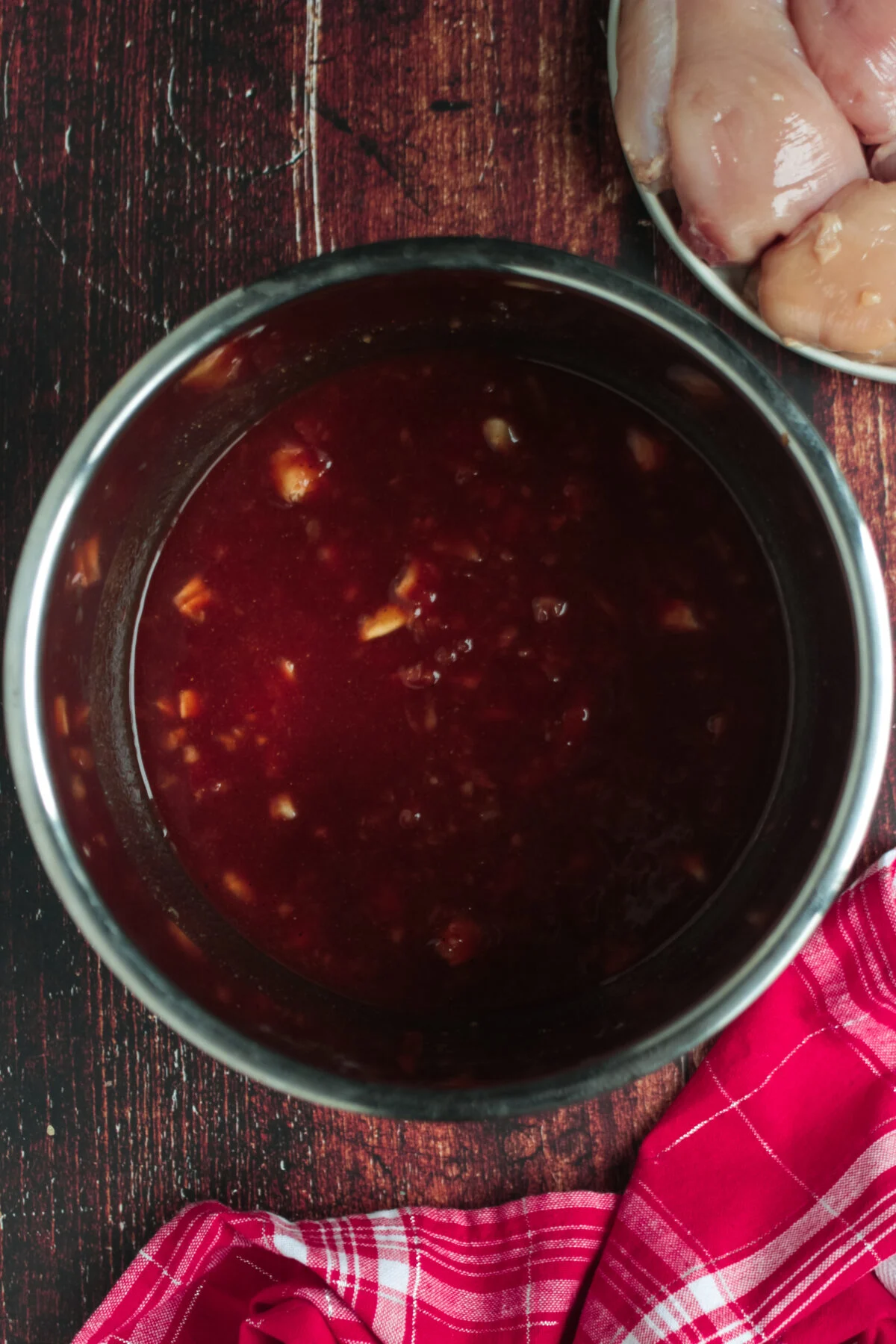 BBQ sauce combined with onion and seasonings in an instant pot.