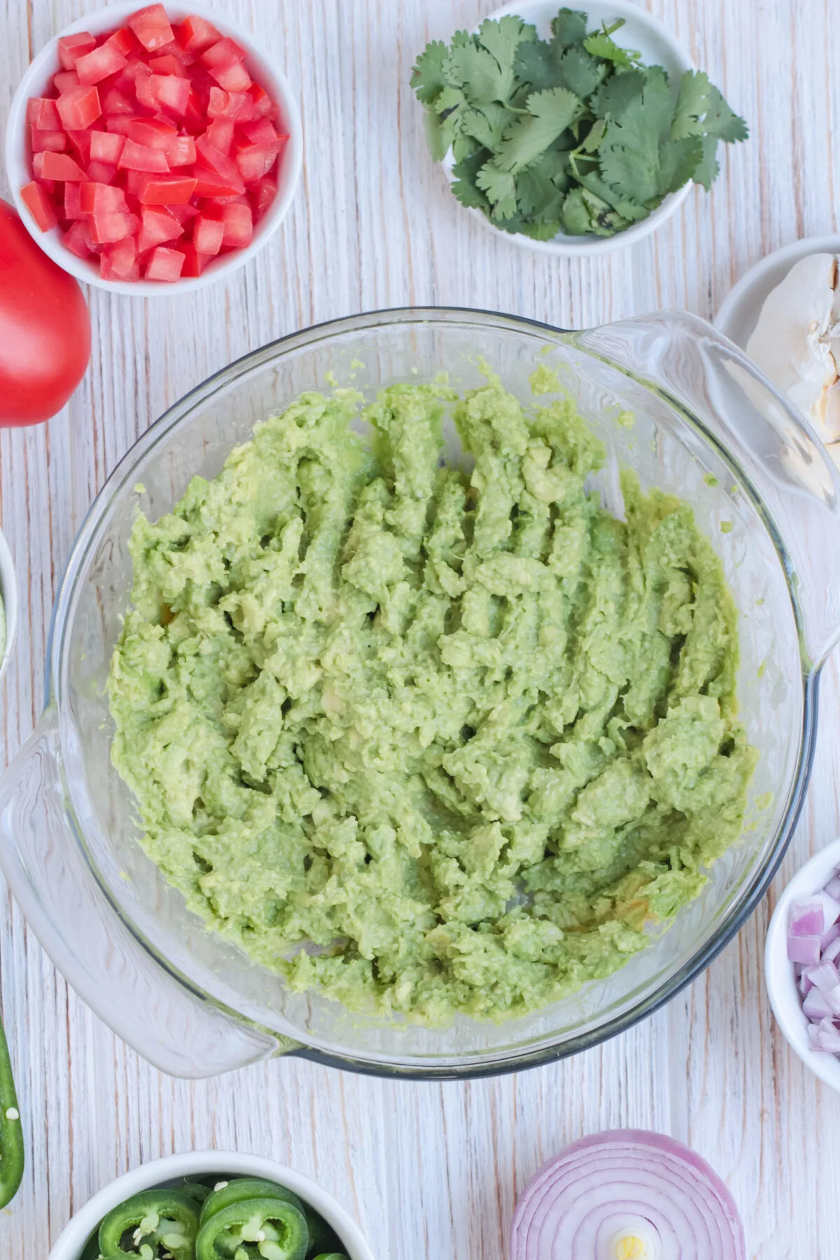 Avocados mashed up in a bowl.