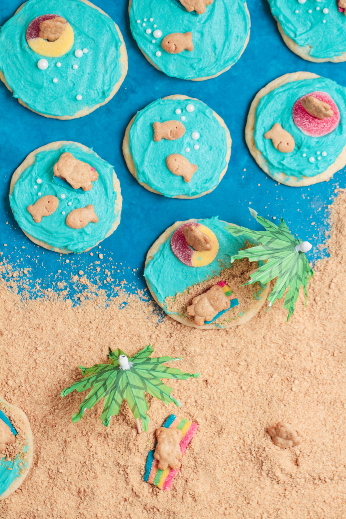 Create an ocean-inspired treat with this easy recipe for beach cookies featuring cream cheese frosting, teddy grahams, and candy decorations!