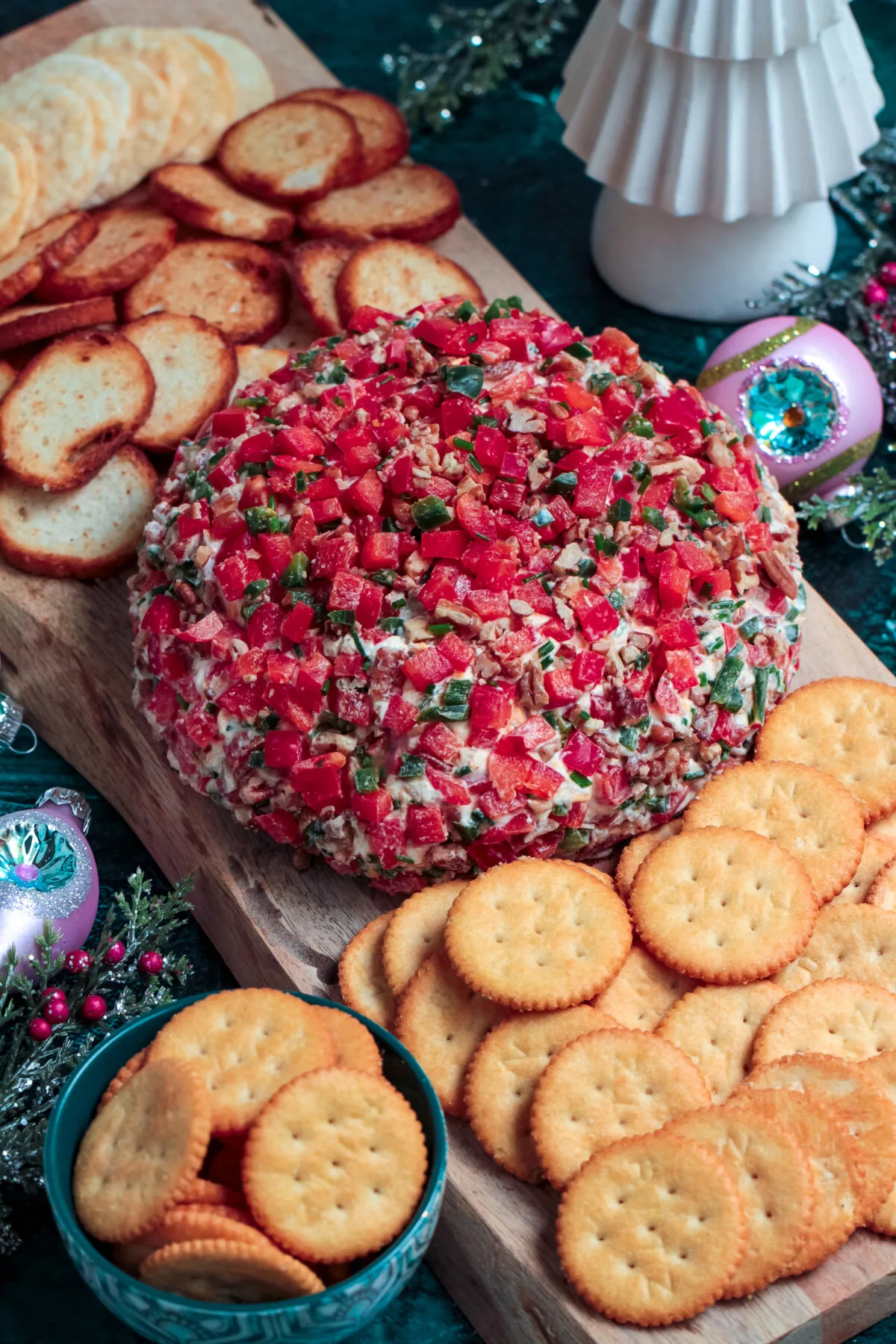 Celebrate the holidays with this simple recipe for a Christmas cheese ball made with sharp cheddar, bell peppers, pecans, and more!