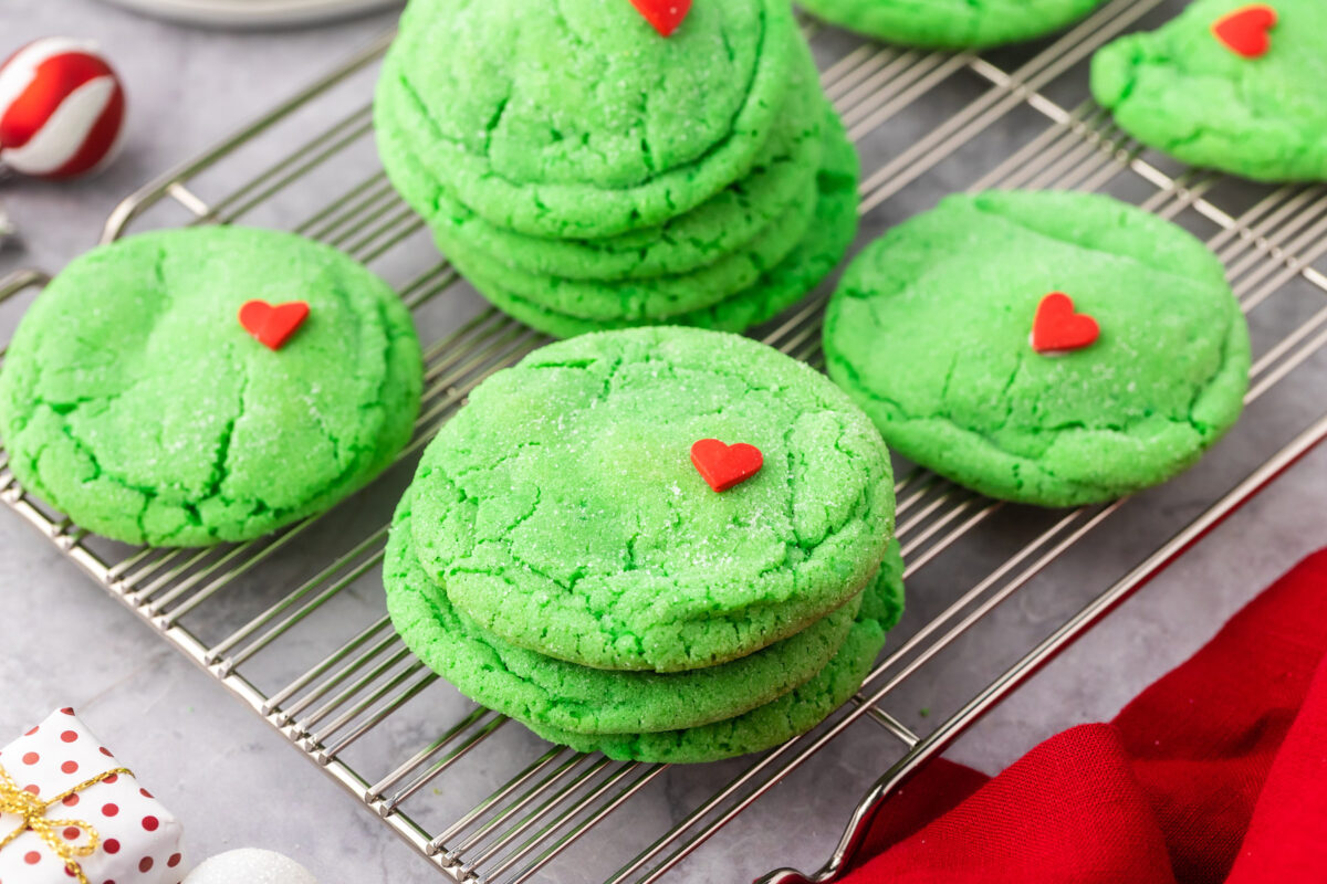 Baked Grinch sugar cookies on a cooling rack.