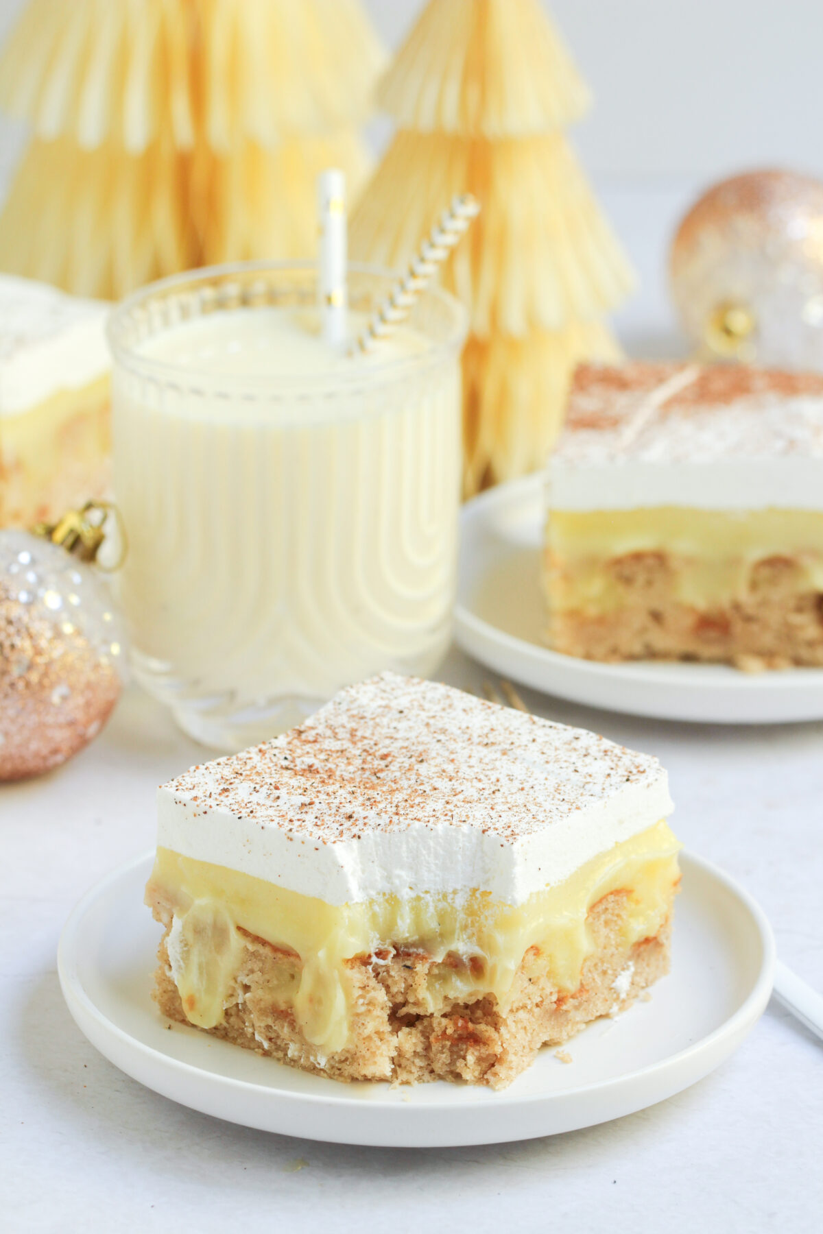 Celebrate the holidays with this eggnog poke cake topped with a creamy eggnog pudding filling and whipped topping dusted with nutmeg.