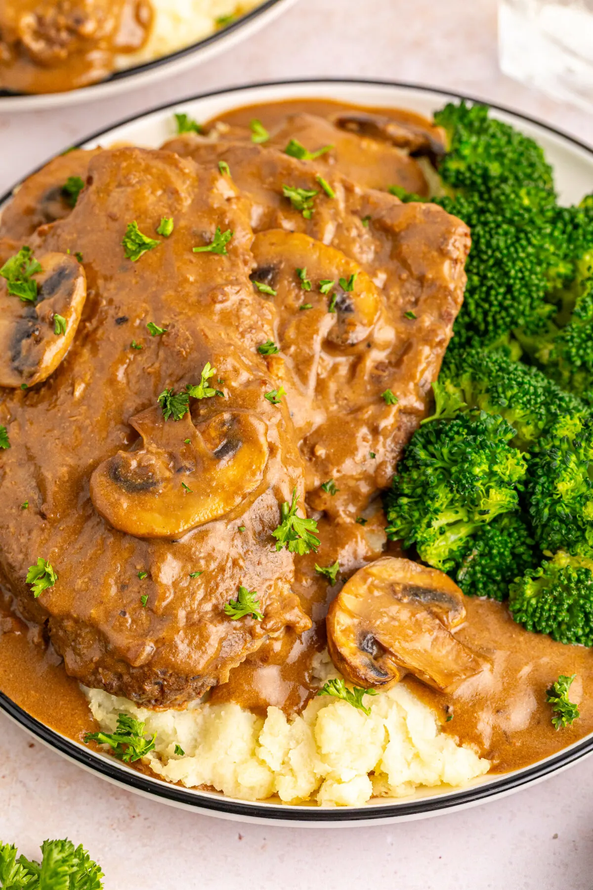 Try this delicious slow cooker cube steak recipe! Tender, juicy meat smothered in savoury gravy and mushrooms - a perfect comfort food dish.