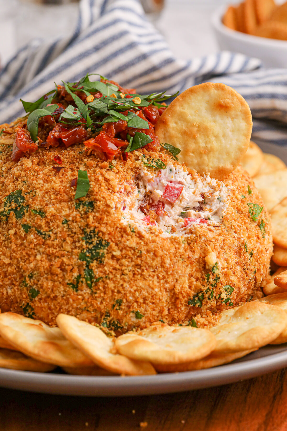Elevate your party food game with this delicious and easy-to-make bruschetta cheese ball recipe. Your guests will thank you!