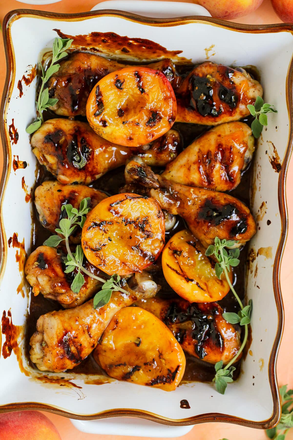 Grilled peach glazed chicken drumsticks are basted in a sweet peach glaze with balsamic - perfect for summer BBQs or family dinners.
