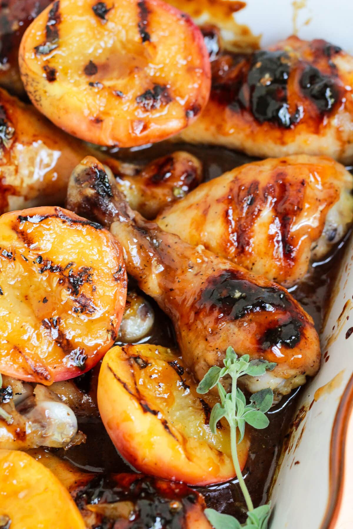 Grilled peach glazed chicken drumsticks are basted in a sweet peach glaze with balsamic - perfect for summer BBQs or family dinners.