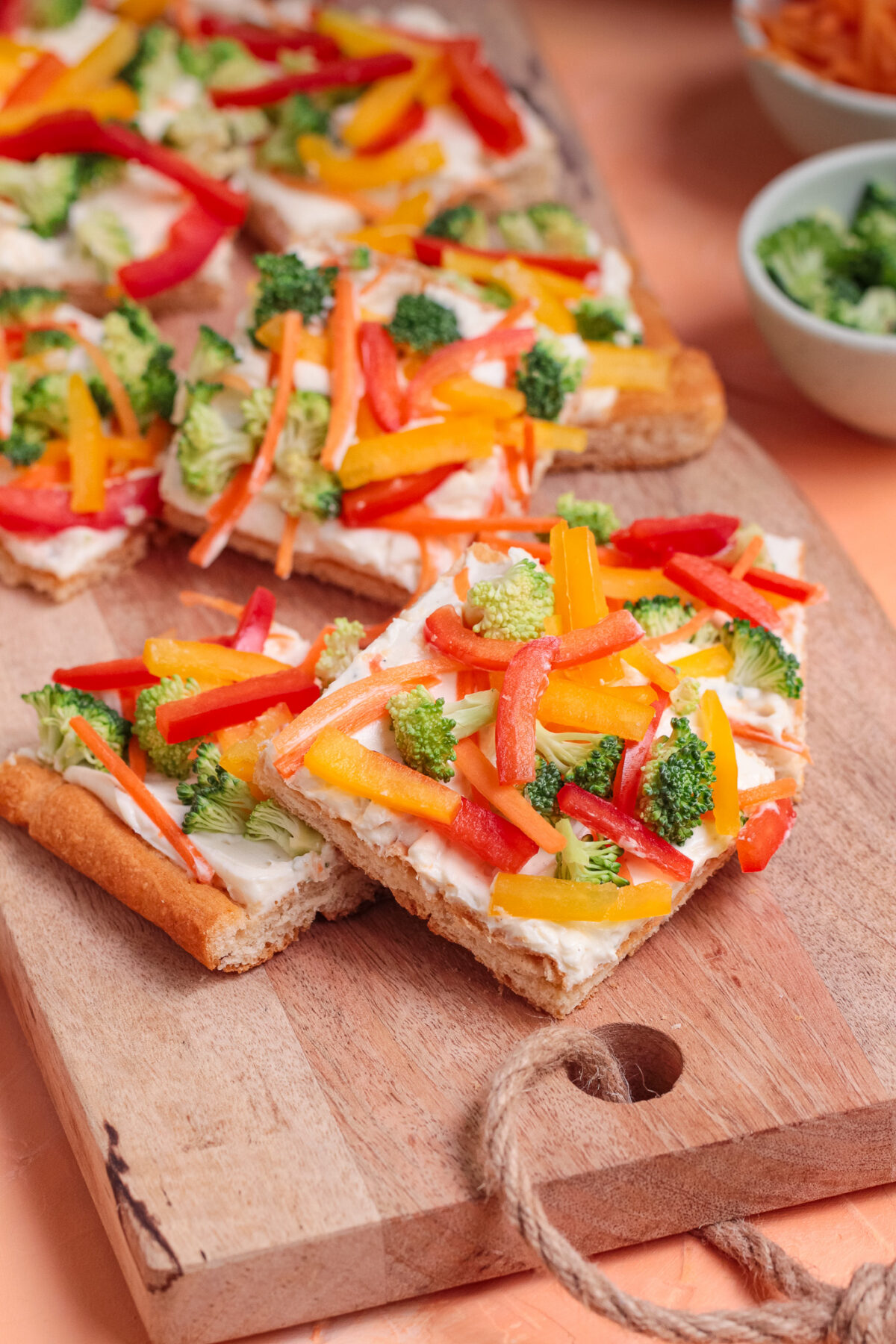Easy cold veggie pizza with crescent roll crust, ranch cream cheese spread, broccoli, carrots, and bell peppers. Perfect for parties.